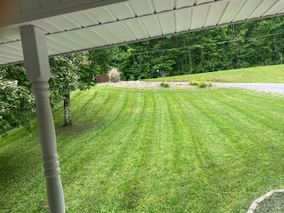 View of a freshly cut lawn from the front porch